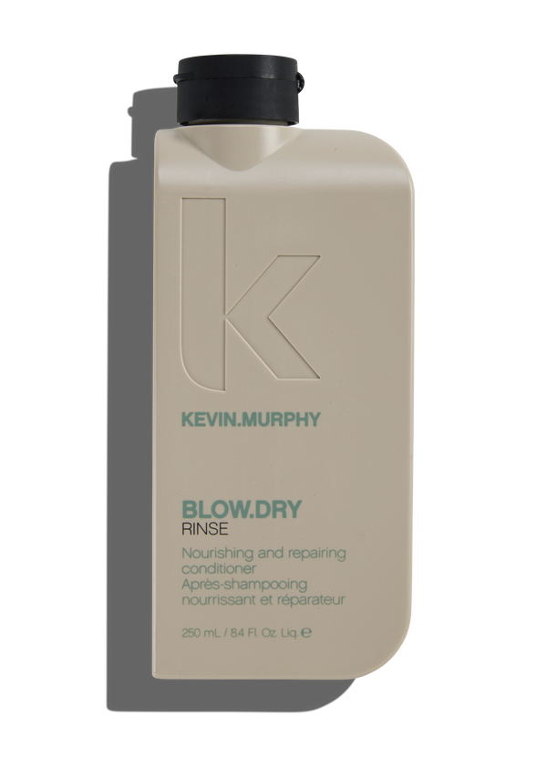 A bottle of Kevin.Murphy Blow.dry Rinse conditioner, with a pump dispenser, labeled for nourishing and repairing hair.