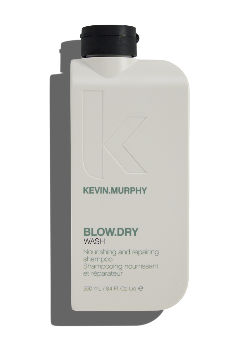 A bottle of Kevin.Murphy Blow.dry Wash shampoo, which is nourishing and repairing, indicated for use after blow drying.