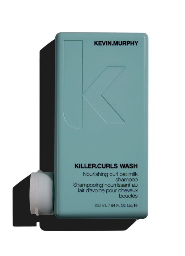 A bottle of Kevin Murphy Killer Curls Wash shampoo with a soft teal label, designed for cleansing and defining curly hair