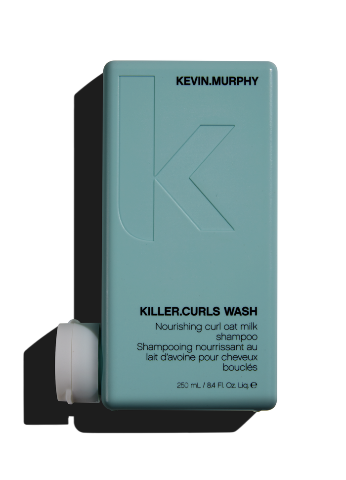 A bottle of Kevin Murphy Killer Curls Wash shampoo with a soft teal label, designed for cleansing and defining curly hair