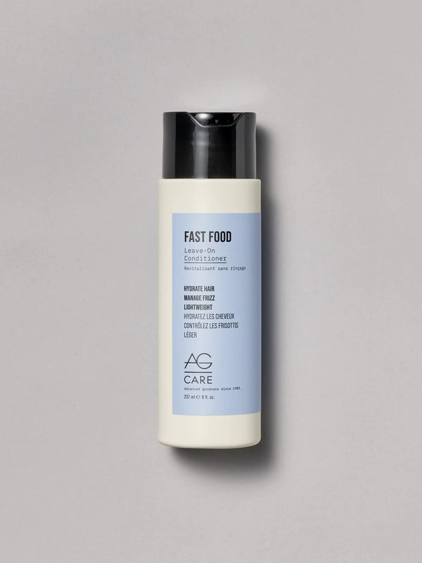Pastel blue label leave-in conditioner with aloe and abyssinian oil from an eco-friendly salon in Toronto, frizz control