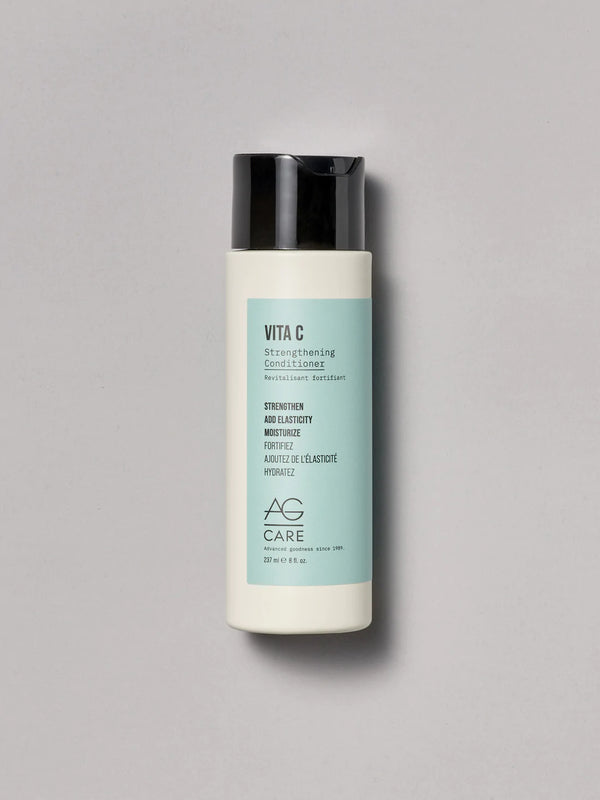 Pastel teal label conditioner with vitamin C and squalane to strengthen and moisturize from an eco-friendly salon in Toronto