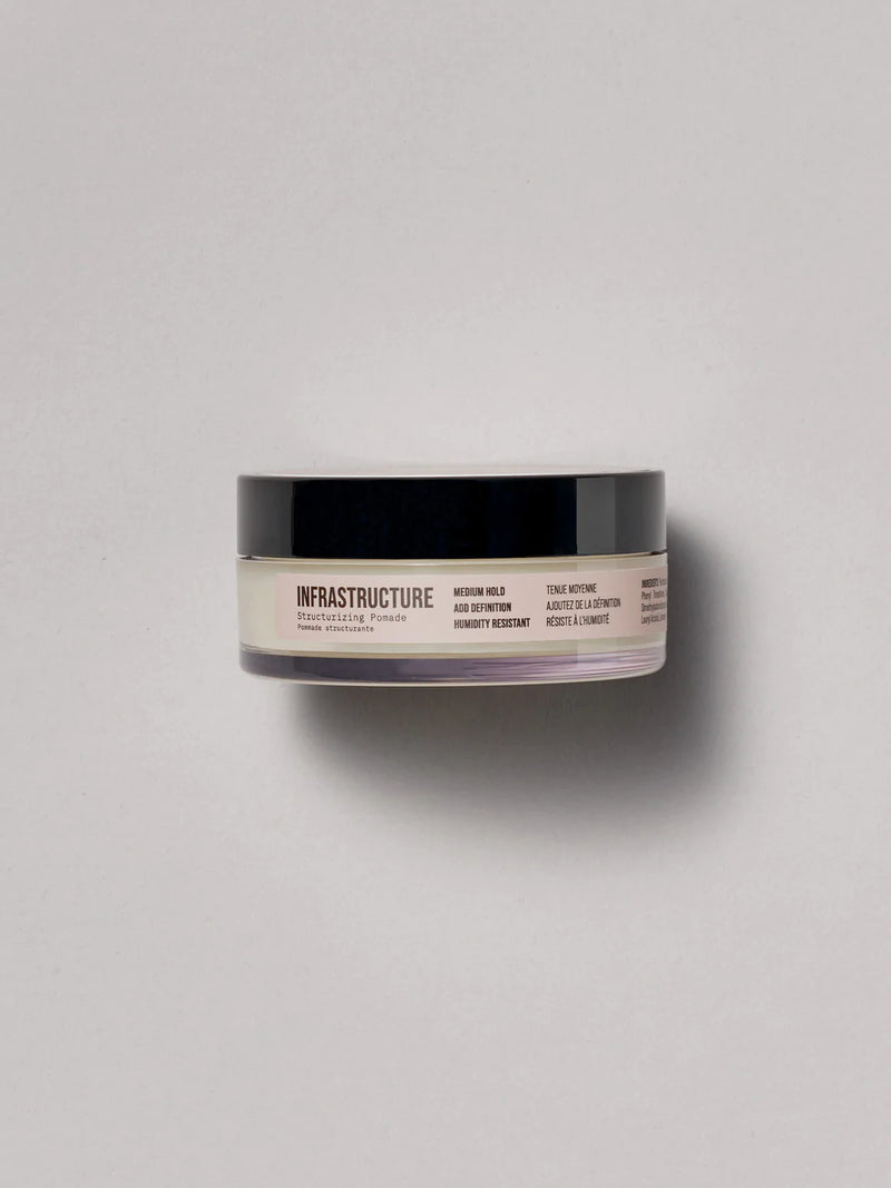 Plastic circular container, AG Pomade at Green Circle Salon Toronto. Medium hold pomade adds texture, definition, and humidity resistance.