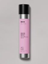 Silver long can with pink label, AG Root Volumizer Spray at Green Circle Salon Toronto. Boosts volume, protects from heat, and supports hair growth.
