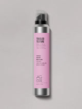 Silver can with pink label, AG Texture Styling Spray at Green Circle Salon Toronto. Adds volume, shine, and piecey texture with seaweed extract.
